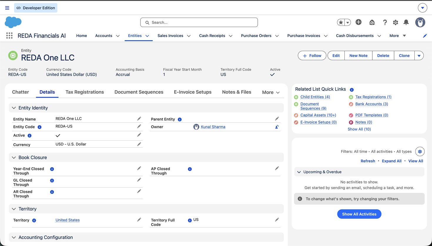 An Entity record page in REDA Financials AI for REDA One LLC. The highlights panel shows Entity Code (REDA-US), Currency Code (United States Dollar), Accounting Basis (Accrual), Fiscal Year Start Month (1), Territory Full Code (US) and Active. The Details tab shows the Entity Identity, Book Closure, Territory and Accounting Configuration sections, and the Related List Quick Links panel links to Child Entities, Document Sequences, Capital Assets, Tax Registrations, Bank Accounts and PDF Templates.