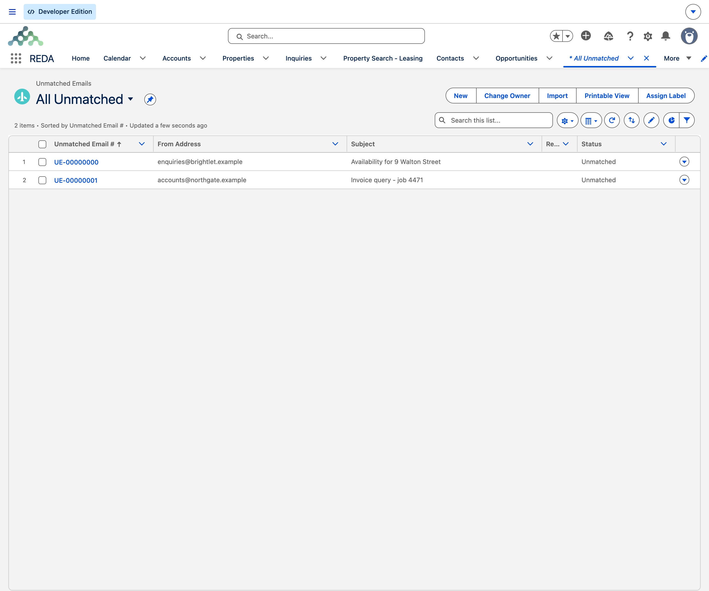 The Unmatched Emails tab in the REDA app showing the All Unmatched list view with two inbound emails, each row carrying its Unmatched Email number, a blurred From Address, the email subject, and a Status of Unmatched.